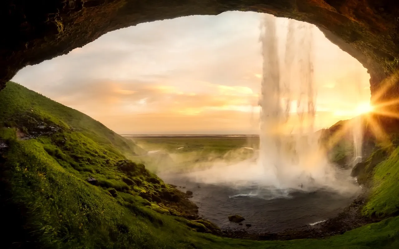 Waterfall framed by arch formation
