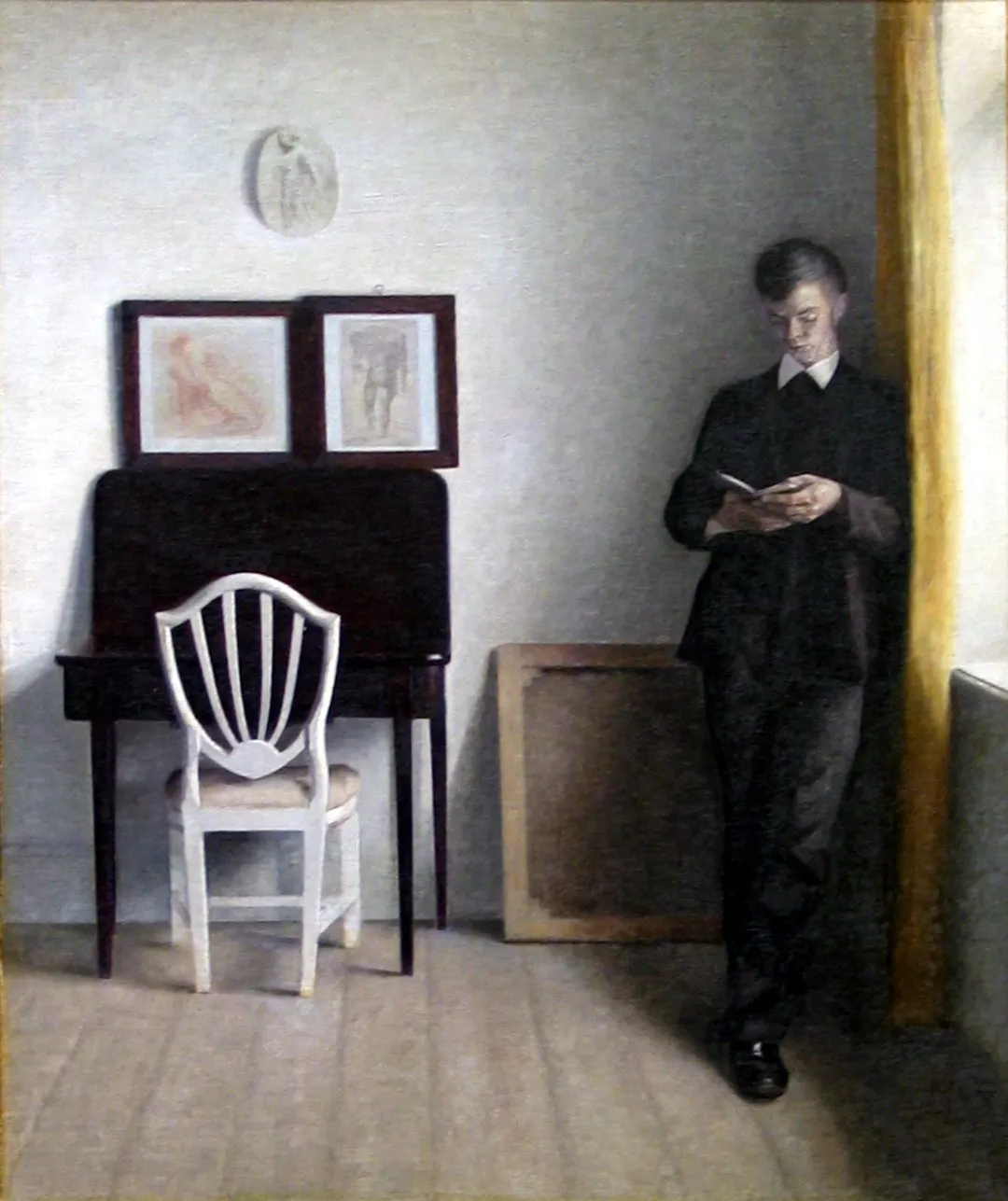 Interior with Young Man Reading by Vilhelm Hammershoi, 1898